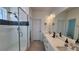 Modern bathroom with double vanity, frameless glass shower, and sleek tile at 8981 Bellsong Circle Cir, Littleton, CO 80125
