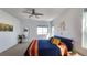 Bright bedroom featuring a blue upholstered bed, and scenic outdoor views at 8981 Bellsong Circle Cir, Littleton, CO 80125