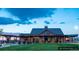 Striking view of community house, with expansive windows and inviting outdoor space at 8981 Bellsong Circle Cir, Littleton, CO 80125