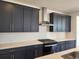 Modern kitchen featuring dark cabinets, stainless steel appliances, and stylish backsplash at 8981 Bellsong Circle Cir, Littleton, CO 80125