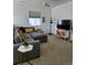 Inviting living room with plush gray sectional, stylish decor, and neutral carpet at 8981 Bellsong Circle Cir, Littleton, CO 80125