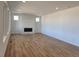 Bright living room with hardwood floors and a modern fireplace with white marble surround at 8981 Bellsong Circle Cir, Littleton, CO 80125