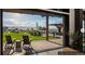 Relaxing outdoor seating area with chairs, tables and views of the green lawn and distant mountains at 8981 Bellsong Circle Cir, Littleton, CO 80125
