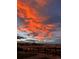 Stunning sunset sky with vibrant orange and pink clouds over a peaceful landscape and picket fence at 8981 Bellsong Circle Cir, Littleton, CO 80125