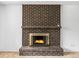 A brick fireplace is featured with classic brick and a mantle at 9327 W Arizona Ave, Lakewood, CO 80232