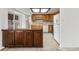 Kitchen with wood cabinets, countertop island and appliances, leading to backyard at 9327 W Arizona Ave, Lakewood, CO 80232