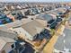 An aerial view of a home boasting a cozy backyard patio, outdoor firepit and yard at 14160 Ivanhoe St, Thornton, CO 80602