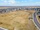 Aerial view of community park featuring a large open field and playground at 14160 Ivanhoe St, Thornton, CO 80602