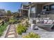 Lush backyard landscaping with a stone pathway leading to the patio at 14160 Ivanhoe St, Thornton, CO 80602