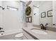 Stylish bathroom features a tiled tub, vanity with granite countertop and decorative accents at 14160 Ivanhoe St, Thornton, CO 80602