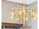 Close-up of a decorative chandelier with crystal accents, adding elegance to the home's interior design at 14160 Ivanhoe St, Thornton, CO 80602