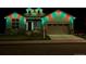 Charming home at night with holiday lighting and a two-car garage at 14160 Ivanhoe St, Thornton, CO 80602
