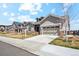 Charming home with a two-car garage, stone accents, and manicured front yard at 14160 Ivanhoe St, Thornton, CO 80602