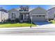 Charming single-story home featuring a well-maintained lawn, a two-car garage, and beautiful stone accents at 14160 Ivanhoe St, Thornton, CO 80602