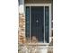 Elegant front door with decorative glass sidelights and stone surround, enhancing the home's curb appeal at 14160 Ivanhoe St, Thornton, CO 80602