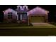 Charming home exterior illuminated with vibrant, colorful holiday lights at night at 14160 Ivanhoe St, Thornton, CO 80602
