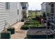 Backyard garden area features raised garden beds and pea stone ground cover at 14160 Ivanhoe St, Thornton, CO 80602