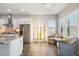 Bright eat-in kitchen features stainless appliances, hydroponic stands, and lots of natural light at 14160 Ivanhoe St, Thornton, CO 80602