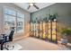 Bright living room with large window, modern ceiling fan and built-in plant displays at 14160 Ivanhoe St, Thornton, CO 80602