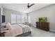 Cozy main bedroom with carpet flooring, plantation shutters and dresser with television at 14160 Ivanhoe St, Thornton, CO 80602