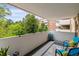Relaxing balcony with comfortable seating and a scenic view of the lush landscaping at 2880 S Locust St # 305N, Denver, CO 80222