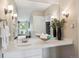 Bright bathroom vanity with great lighting, a large mirror, and elegant decor at 2880 S Locust St # 305N, Denver, CO 80222