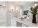 Bathroom vanity with great lighting, a large mirror, and elegant decor at 2880 S Locust St # 305N, Denver, CO 80222