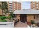 Building entrance featuring double doors, brick exterior, and landscaped surroundings at 2880 S Locust St # 305N, Denver, CO 80222