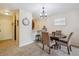 Inviting dining area with a modern chandelier, conveniently located near the kitchen and living spaces at 2880 S Locust St # 305N, Denver, CO 80222