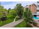 Beautiful landscaping surrounds this building, complete with mature trees and a pool at 2880 S Locust St # 305N, Denver, CO 80222