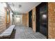 Hallway with brick walls, carpeted floor, and elevator access at 2880 S Locust St # 305N, Denver, CO 80222