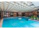 Bright indoor pool area with clear blue water, brick accents, and ample natural light, perfect for year-round enjoyment at 2880 S Locust St # 305N, Denver, CO 80222