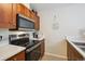 This kitchen features wooden cabinets, stainless steel appliances, and granite countertops at 2880 S Locust St # 305N, Denver, CO 80222