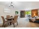 Open floor plan combining living, dining areas, and a balcony overlooking trees at 2880 S Locust St # 305N, Denver, CO 80222
