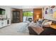 Inviting living room with comfortable gray sectional, wood accents, and sliding glass doors to the balcony at 2880 S Locust St # 305N, Denver, CO 80222