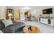 Bright living space with a gray sectional and views of the dining area and kitchen at 2880 S Locust St # 305N, Denver, CO 80222