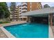 Refreshing outdoor pool with clear blue water, surrounded by a patio area, and a view of the building at 2880 S Locust St # 305N, Denver, CO 80222