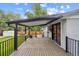 Inviting back deck with covered patio, railing, and sliding door access at 2843 S Otis St, Denver, CO 80227