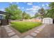 Expansive backyard with lush green grass, privacy fence, and shed for outdoor storage at 2843 S Otis St, Denver, CO 80227