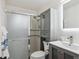 Bathroom with gray vanity, glass shower, and modern fixtures at 2843 S Otis St, Denver, CO 80227