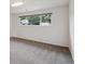 Bedroom with gray carpet, white walls, and a window with a view of the outdoors at 2843 S Otis St, Denver, CO 80227