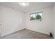 Bedroom with gray carpet, white walls, and a window with a view of the outdoors at 2843 S Otis St, Denver, CO 80227