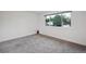 Bedroom with gray carpet, white walls, and a window with a view of the outdoors at 2843 S Otis St, Denver, CO 80227