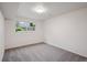 Bedroom with gray carpet, white walls, and a window with a view of the outdoors at 2843 S Otis St, Denver, CO 80227