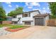 Two-story home featuring an attached garage and a neatly landscaped front yard at 2843 S Otis St, Denver, CO 80227