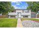 Charming two-story home with a well-maintained front yard and an inviting entrance at 2843 S Otis St, Denver, CO 80227