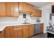 Well-lit kitchen with wood cabinets, stainless steel appliances, and ample counter space at 2843 S Otis St, Denver, CO 80227