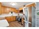 Modern kitchen featuring stainless steel appliances and wood cabinets at 2843 S Otis St, Denver, CO 80227