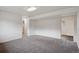 Spacious living room with gray carpet and white walls, with a view into the kitchen at 2843 S Otis St, Denver, CO 80227
