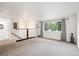 Spacious living room featuring neutral carpet, large windows and modern railing at 2843 S Otis St, Denver, CO 80227